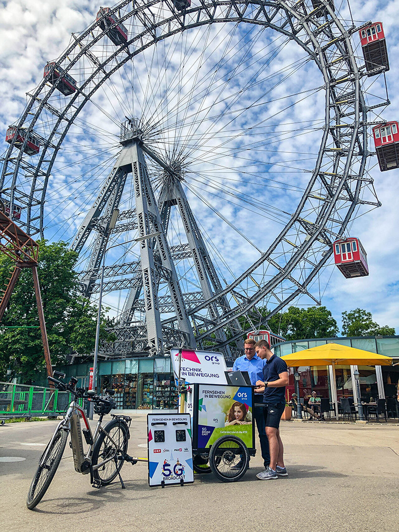 Technicians with measuring trolley in front of Vienna Giant Ferris Wheel