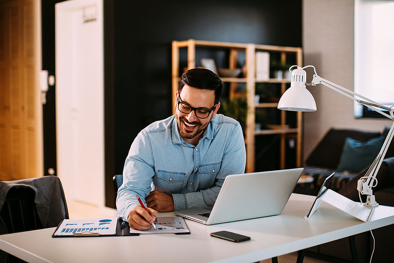 man happily working at homeoffice