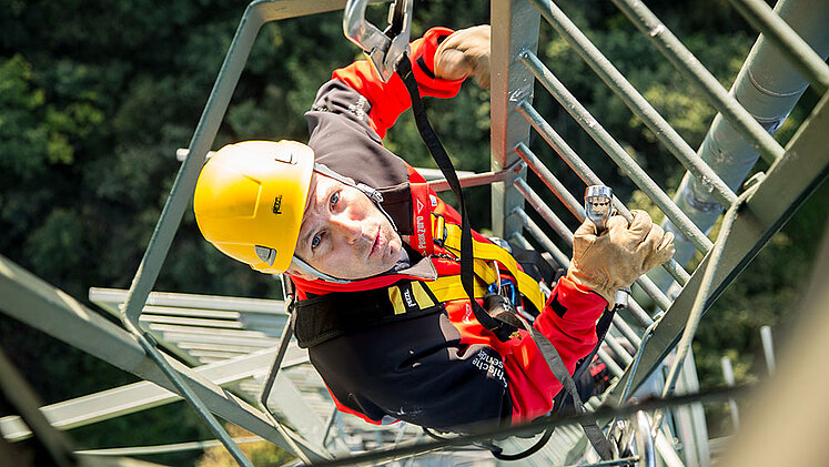 ORS technicians climbing the transmission tower