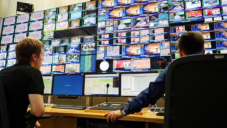 Technicians look at many monitors in the ORS Broadcast Centre